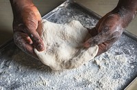 Man holding dough in the kitchen