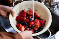 Rinsing fresh strawberries and blueberries