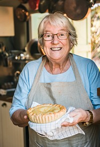 A grandmother carrying homemade fruit pie food photography recipe idea