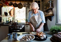 Senior woman cooking in a countryside kitchen