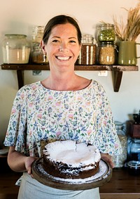 Happy baker with a chocolate fudge cake