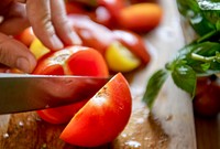 Woman slicing tomatoes for pasta sauce