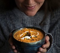 Woman holding a bowl of soup food photography recipe idea