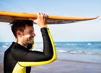 A man carrying a surfboard