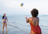 Women playing volleyball on the beach