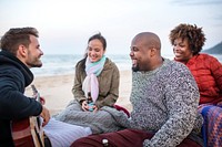 Friends drinking beer on the beach