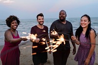 Friends celebrating with sparklers at the beach