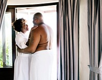 Couple standing together in hotel room