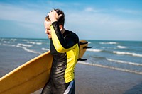 A man carrying a surfboard