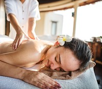 Woman relaxing with a herbal massage