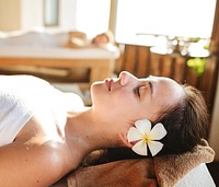 Caucasian woman relaxing with herbal massage