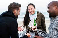 Friends drinking beer on the beach