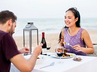 Couple enjoying a romantic dinner at the beach