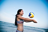 A woman playing beach volleyball