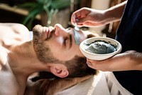 Man getting a mud mask at a spa