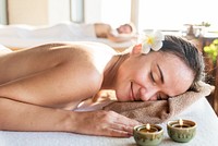 Woman relaxing with a herbal massage