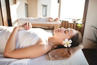 Caucasian woman relaxing with herbal massage