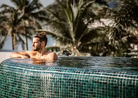 Handsome guy relaxing in swimming pool