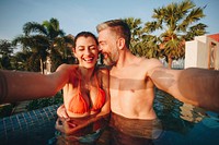 Couple taking a selfie in a pool