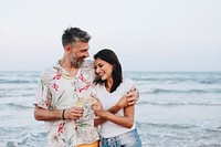 Couple enjoying a glass of wine by the beach