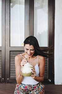 Woman drinking a fresh coconut
