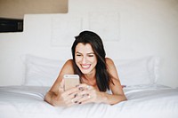 Woman using a mobile phone in bed