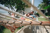 Couple relaxing in a hammock by the beach