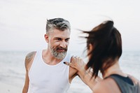 Couple stretching at the beach