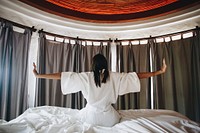 Woman waking up in a hotel room