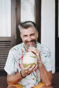 Man drinking a fresh coconut