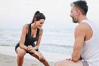 Couple stretching at the beach