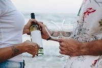 Couple enjoying a glass of wine by the beach