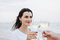 Couple enjoying a glass of wine by the beach