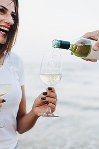 Couple enjoying a glass of wine by the beach