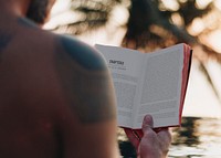 Man reading a book in the swimming pool