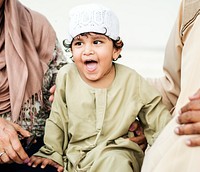 Muslim grandparents with their grandchild