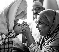 Muslim girl paying respect to mother