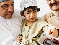 Muslim boy eating dried dates