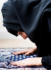 Muslim woman praying in the mosque during the Ramadan