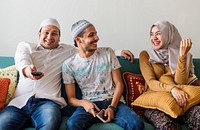Muslim family watching tv at home
