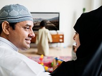 Muslim family relaxing in the home