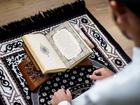 Muslim man studying The Quran