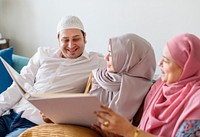 Muslim family looking in a photo album