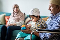 Muslim family relaxing and playing at home