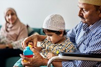 Muslim family relaxing and playing at home