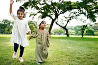 Muslim brother and sister playing in the park