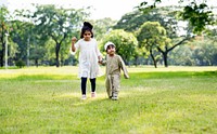 Muslim brother and sister playing in the park