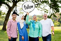 Muslim family holding up a follow sign