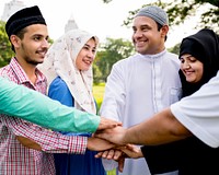 Muslim group of friends stacking hands