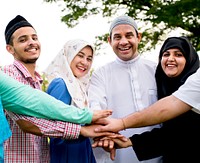 Muslim group of friends stacking hands